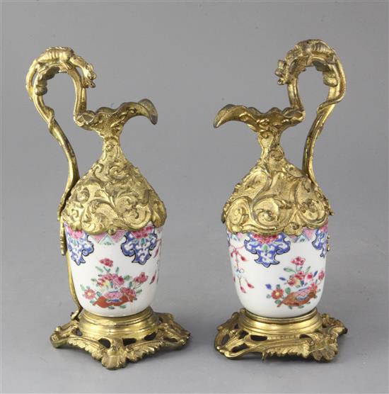 A pair of Chinese export porcelain and French ormolu mounted ewers, 22.5cm high, porcelain damaged